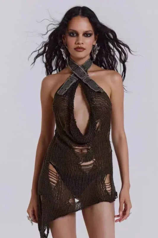 Model wearing a distressed knit halter mini dress with an open cutout and asymmetrical hem