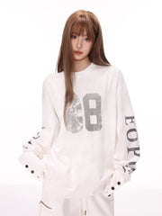 Model wearing a white long sleeve top with a "68" graphic on the front and text on the sleeves.