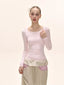 Model wearing a pink long-sleeved square neck top and a beige maxi skirt with pink striped accents.