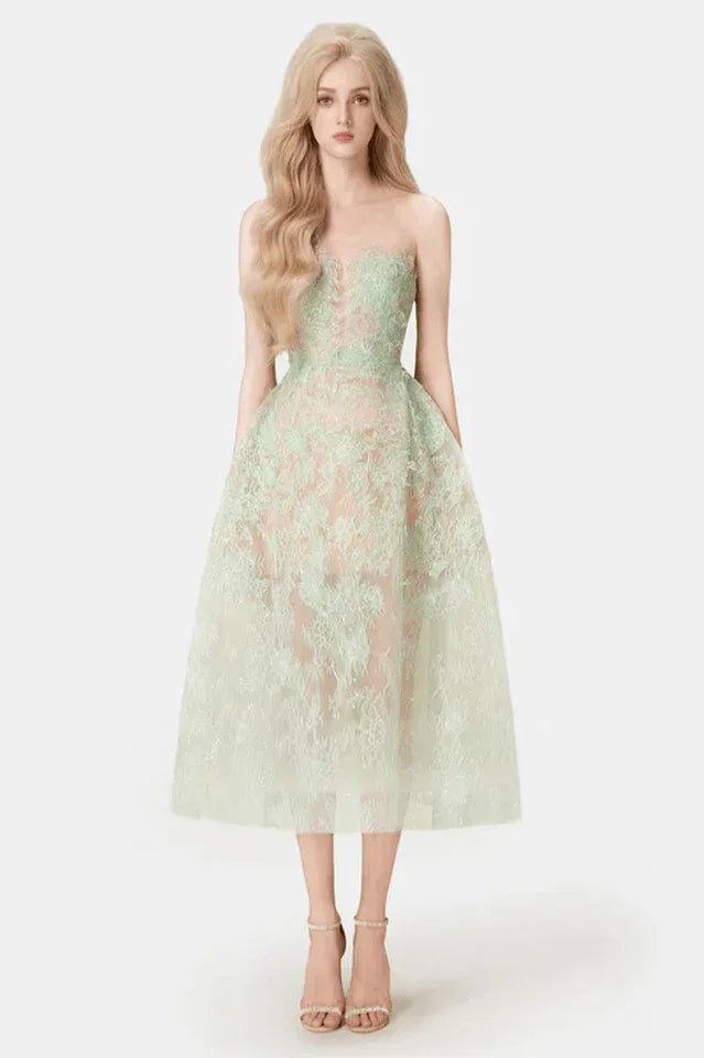 Woman wearing a strapless mint green lace midi dress with a full skirt, front view