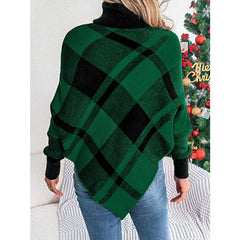 Back view of a woman wearing a green and black plaid turtleneck poncho with blue jeans.