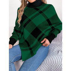 Woman wearing a green and black plaid turtleneck poncho with blue jeans.