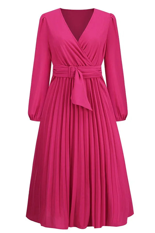 Front view of a long-sleeved pink wrap dress with a pleated skirt and a self-tie belt