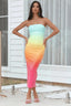 Woman wearing a strapless ombre sequin midi dress with a thigh-high slit, standing outdoors.