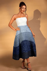 Woman posing in a white and blue ombre textured midi dress