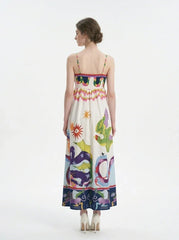 Woman wearing a white sleeveless maxi dress with a colorful graphic print and spaghetti straps, back view