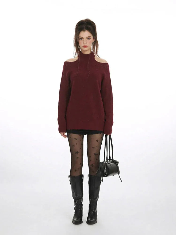 Model wearing a maroon knit sweater with open shoulders, black shorts, star-patterned tights, and black knee-high boots. Main image