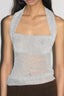 Close-up of a silver sparkly halter top with a sheer lower panel.