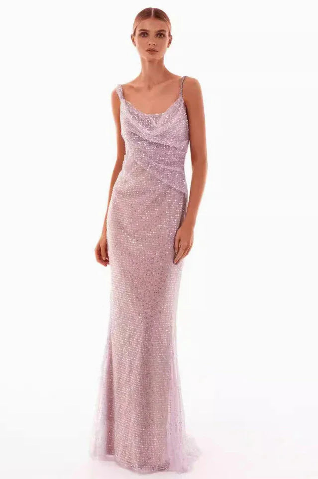 A woman models a sparkling lavender floor-length gown with a cowl neckline and spaghetti straps, front view. Main image