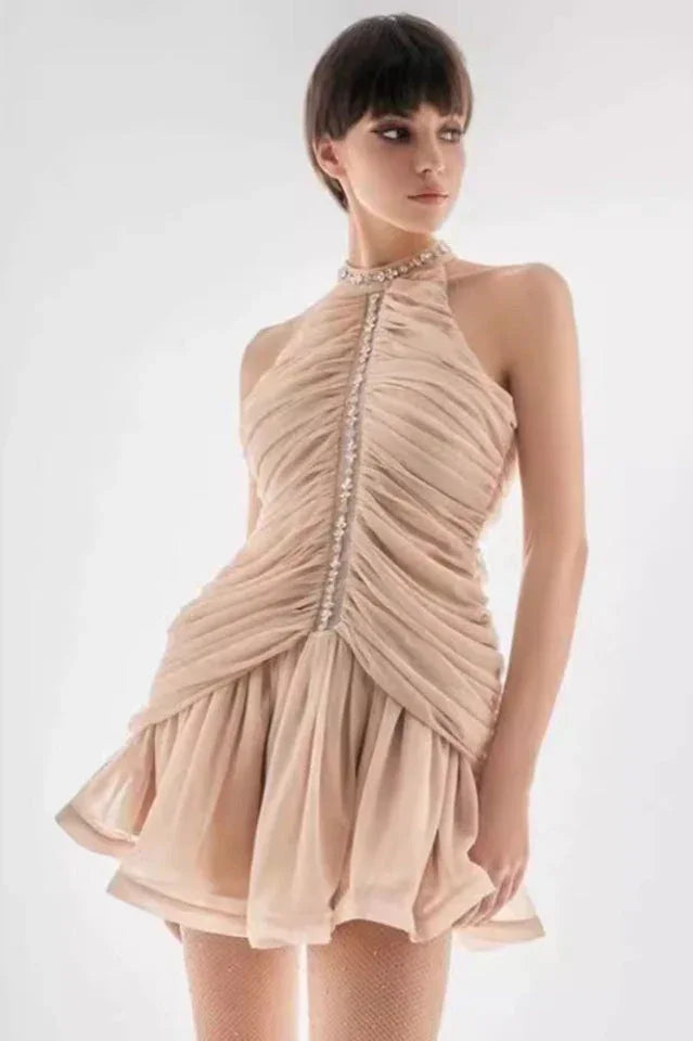 woman in a beige ruched halter neck mini dress with embellished neckline Main image
