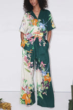 Model wearing a two-piece set with a floral print shirt and wide-leg pants.