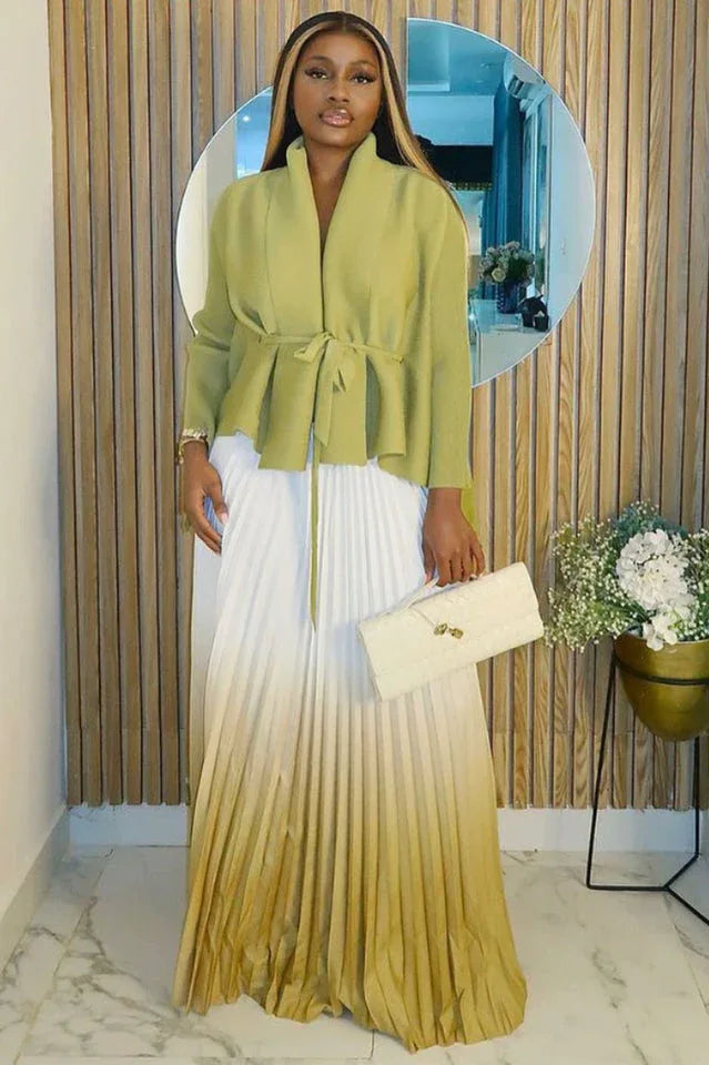 Woman wearing a lime green wrap top and white to lime green ombre pleated maxi skirt with a cream clutch. Main image
