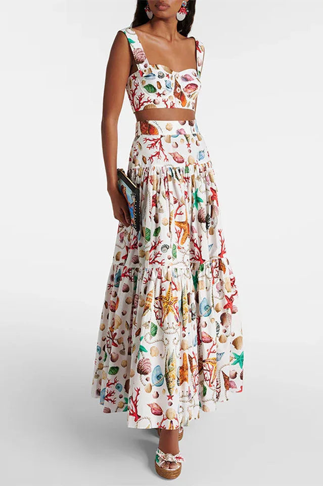 Woman wearing a white seashell print cropped halter top and a tiered maxi skirt. Main image
