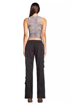 Back view of a woman wearing a marble print mesh tank top and black cargo pants