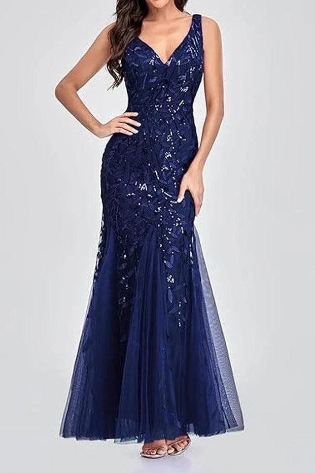 Woman wearing a floor-length navy blue sequined mermaid gown with a V-neckline and sleeveless design.