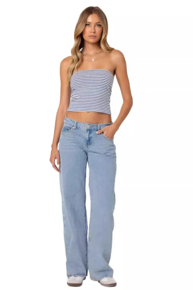 Woman wearing a blue and white striped tube top and light wash wide leg jeans