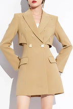 Front view of a tan double-breasted blazer dress with cut-out waist and flap pockets.