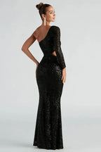 Back view of a woman in a black sequined one-shoulder gown with a mermaid hem.