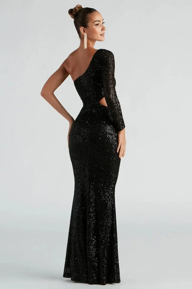 Back view of a woman in a black sequined one-shoulder gown with a mermaid hem.