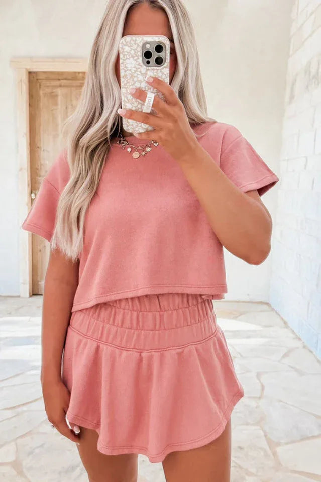 woman wearing a pink cropped t-shirt and matching shorts set Main image