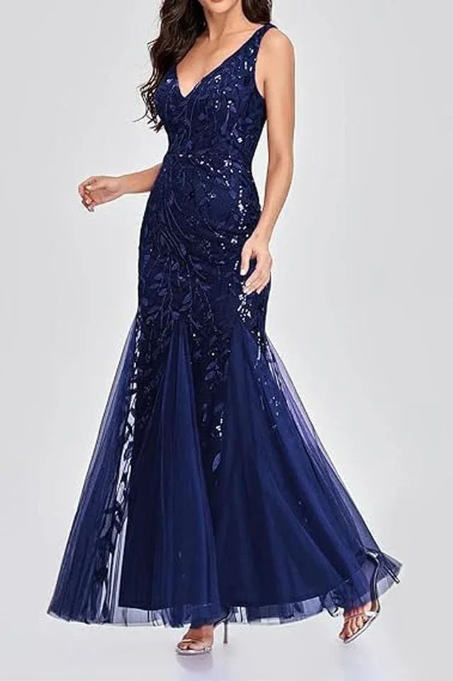 Woman wearing a floor-length navy blue sequined mermaid gown from the side, showcasing the silhouette.
