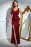 Woman wearing a red sequined evening gown with a high slit and V-neckline