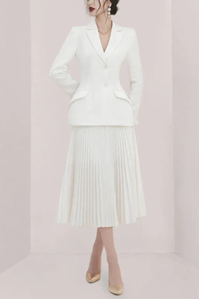 Woman wearing a white pleated skirt suit from the front Main image
