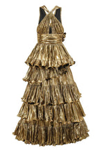 Back view of a gold metallic tiered ruffle halter dress with a cinched waist.
