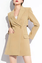 Close-up of a tan double-breasted blazer dress showing embellished lapels and button details.