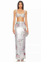 Full-length front view of a woman wearing a silver sequined maxi skirt with a floral print.