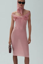 Model wearing a pink off-the-shoulder mesh sheath dress with floral appliqués and a matching headscarf.