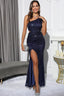 Woman wearing a navy blue sequined one-shoulder evening gown with a high slit and side cut-outs.