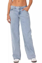 Close-up of light wash wide leg jeans worn by a woman