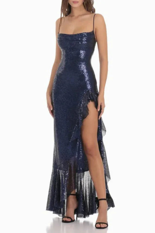woman wearing a navy blue sequined gown with a high slit and ruffle trim, front view Main image