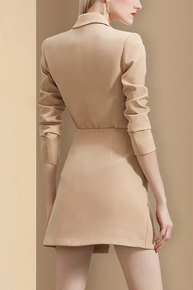 Back view of a woman in a beige blazer dress.