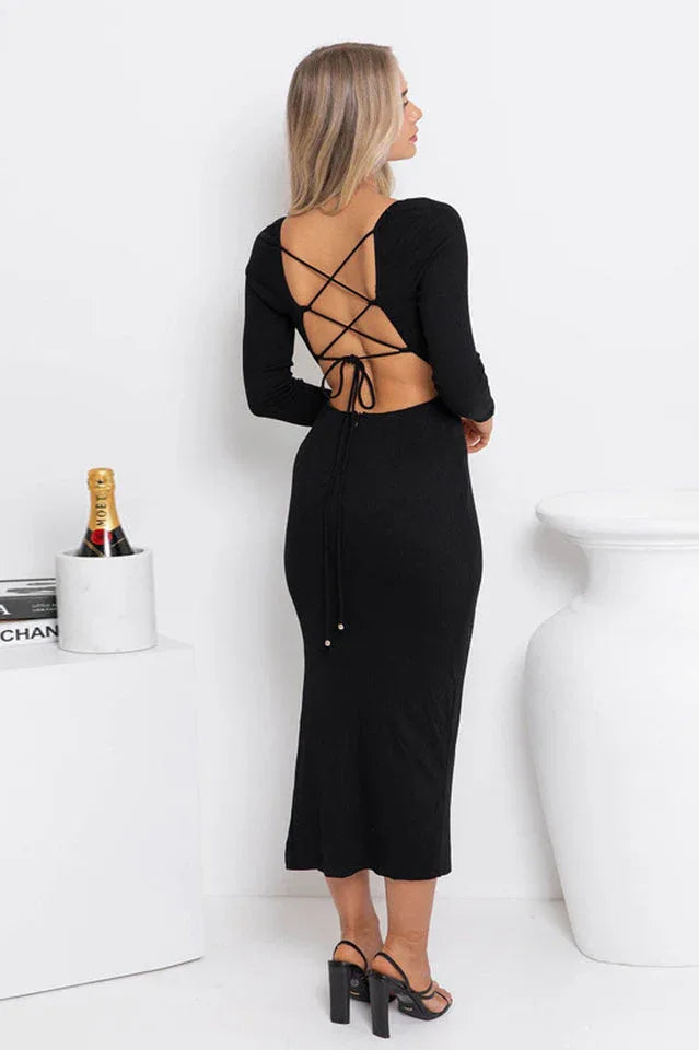 Woman wearing a black long-sleeved midi dress with an open back featuring lace-up detailing, viewed from the back Main image