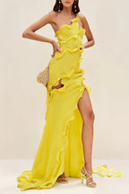 Model posing in a vibrant yellow one-shoulder ruffled gown with a thigh-high slit, highlighting the side view.