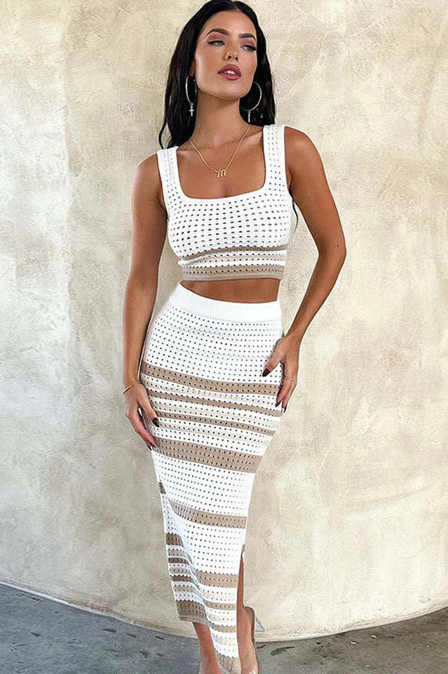 Woman wearing a white and tan striped knit cropped tank top and matching midi skirt with a side slit, front view Main image