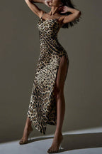Woman wearing a leopard print satin maxi dress with a high slit, standing with her hands behind her head.