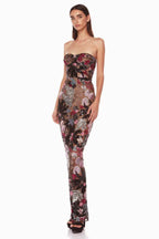 Side view of a woman in a strapless, sequined floral gown. The dress features a form-fitting silhouette that extends to the floor.