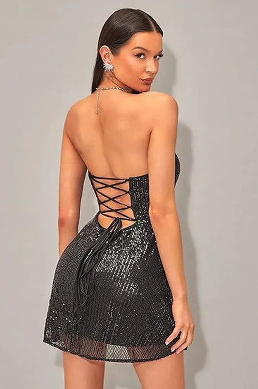 Woman wearing a black sequined strapless dress with a sweetheart neckline and A-line skirt, back view showing lace-up detail