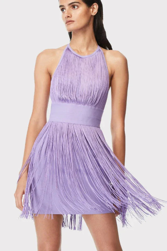 Woman wearing a purple mini dress with fringe detailing and a halter neckline