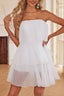 Woman wearing a white strapless tiered chiffon dress