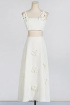 Mannequin wearing a white floral applique cropped top and A-line skirt