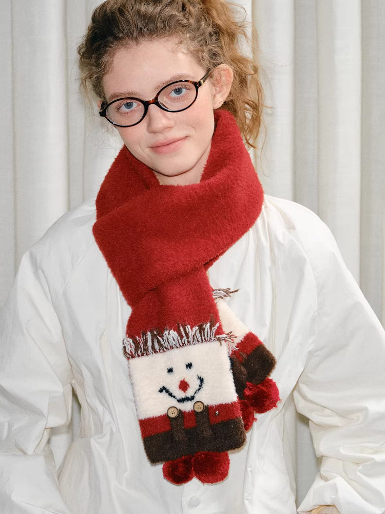 Young woman modeling a red scarf with a snowman motif.
