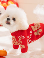 Side view of a white Bichon Frise dog wearing a festive red knit sweater.