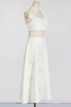 Mannequin wearing a white floral applique cropped top and A-line skirt, side view
