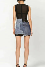 Back view of a model wearing a sleeveless black mesh mini dress with an asymmetrical deconstructed denim overlay