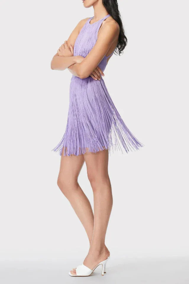 Side view of a woman in a purple fringe mini dress