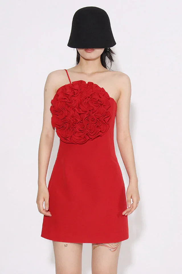 Red one-shoulder mini dress with ruffled floral applique on the bust, worn by a woman with a black bucket hat.